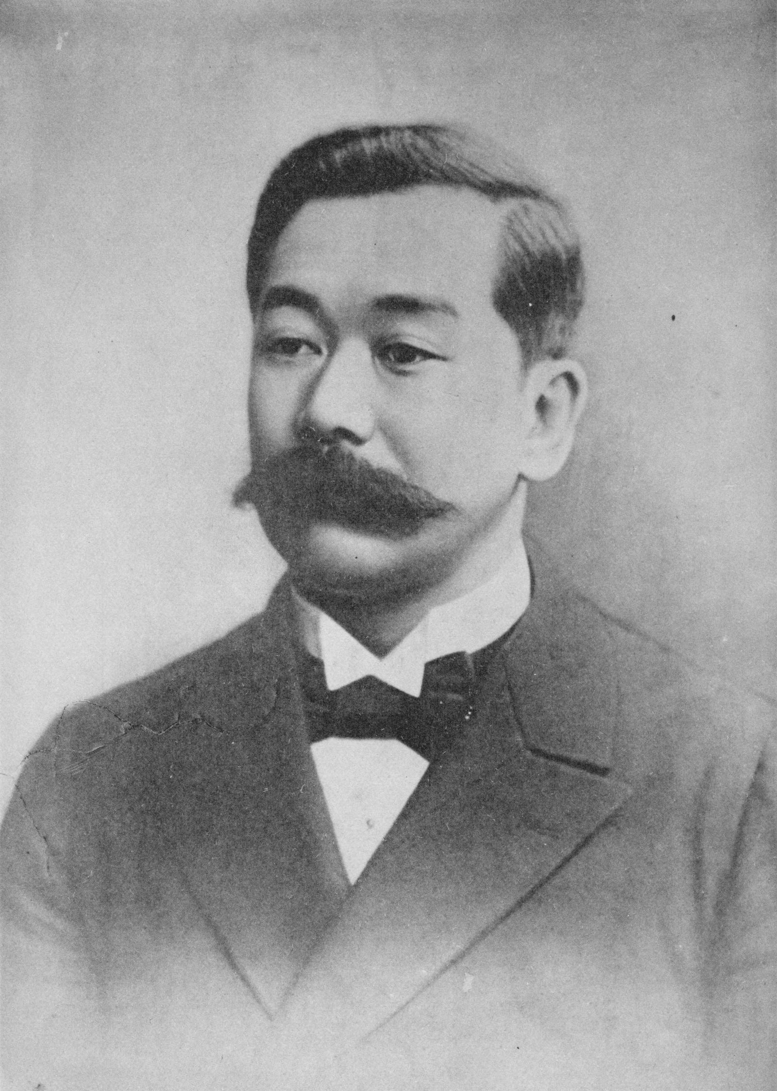 Black and white portrait of Jigoro Kano in formal clothing